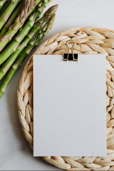 asparagus and blank paper on a mat